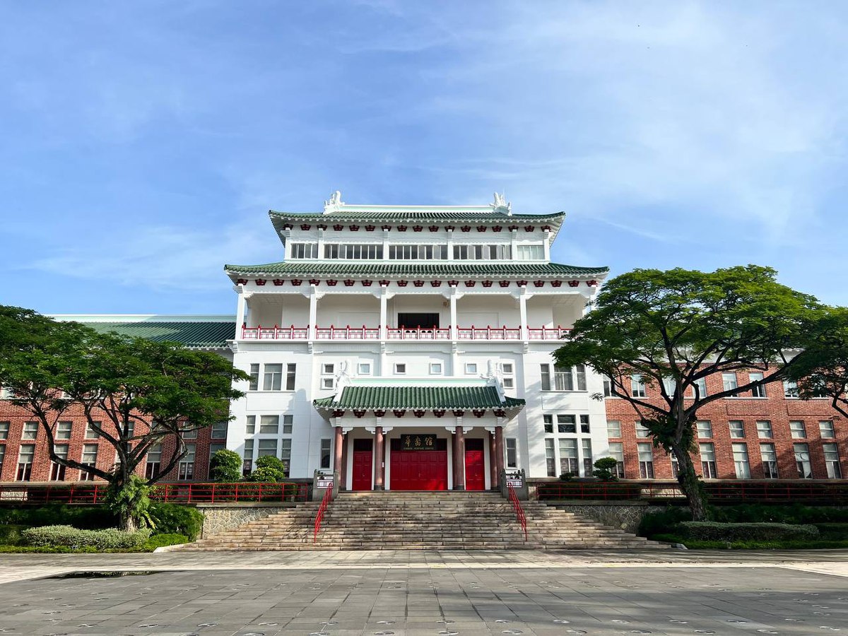 Photo of a heritage building on campus, with a tiered green roof and a red entrance