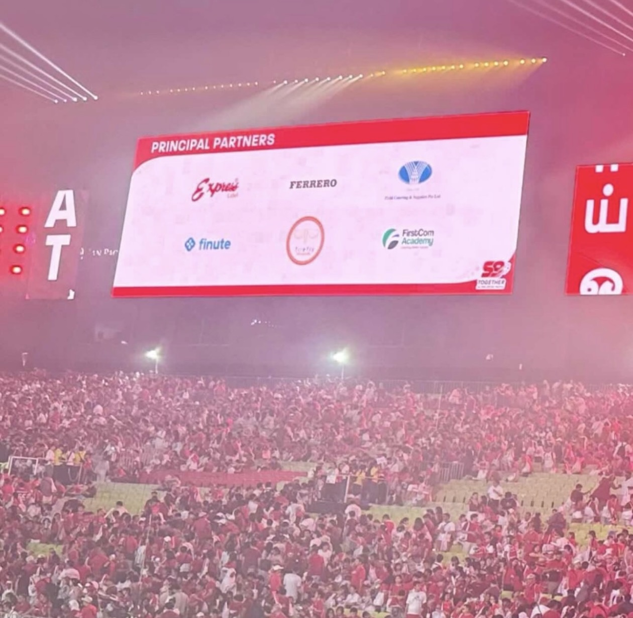 Finute listed among NDP 2024's Principal Partners on the big screen at the Padang